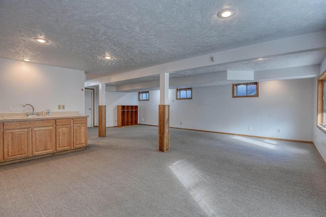 3224 E 28th Ave, Spokane, WA 99223 - below grade area with a sink, a textured ceiling, baseboards, light carpet, and recessed lighting