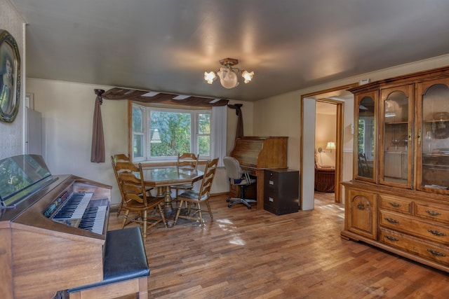 dining space with a chandelier and wood-type flooring