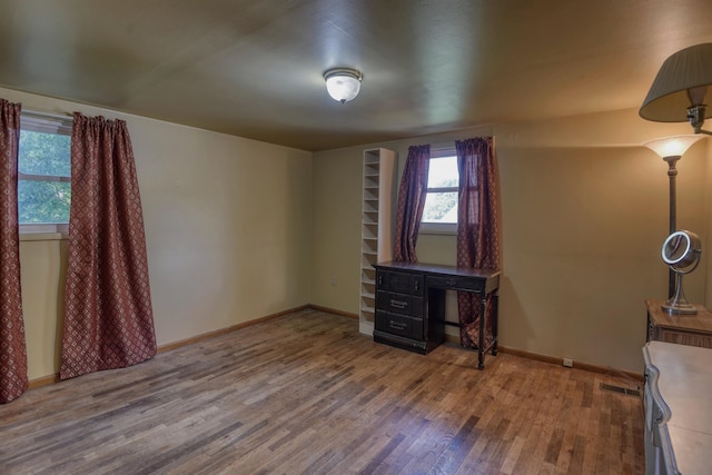 unfurnished bedroom with wood-type flooring