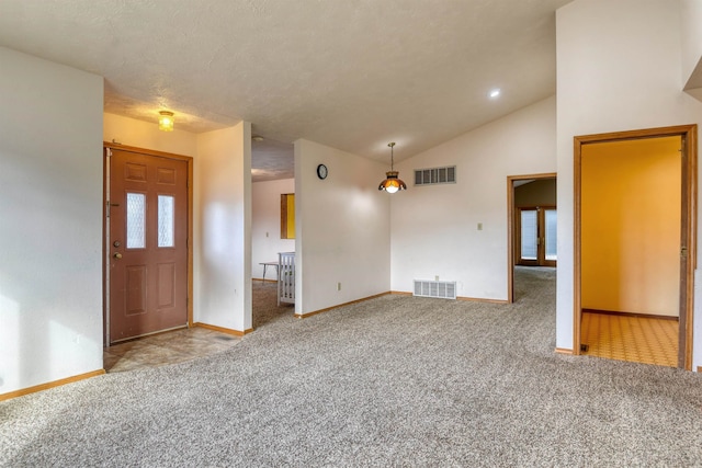 interior space featuring a textured ceiling and high vaulted ceiling