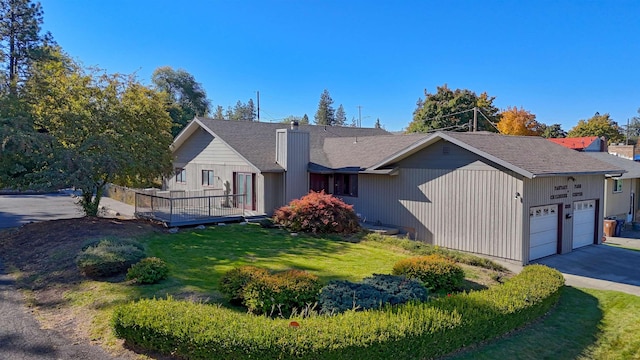 3224 E 28th Ave, Spokane, WA 99223 - ranch-style home with a deck, driveway, a garage, a front lawn, and a chimney