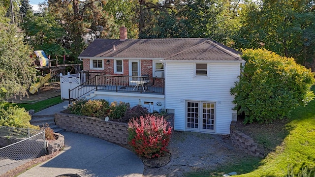 3224 E 28th Ave, Spokane, WA 99223 - back of house with a chimney, brick siding, fence, a patio, and a wooden deck