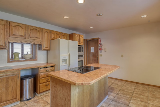 kitchen featuring a center island, appliances with stainless steel finishes, and light tile patterned floors