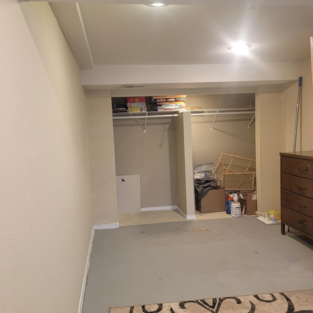 bedroom with a closet and concrete floors