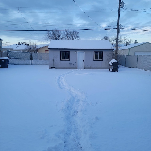 view of snow covered rear of property