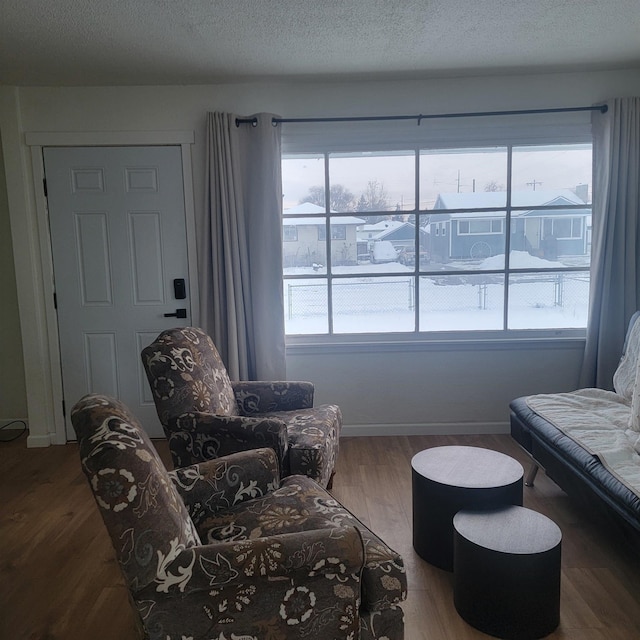 living room with hardwood / wood-style flooring and a textured ceiling