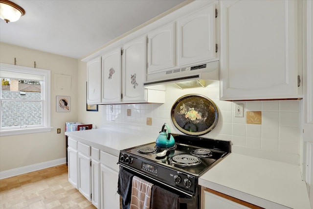 kitchen featuring decorative backsplash, electric range, and white cabinets