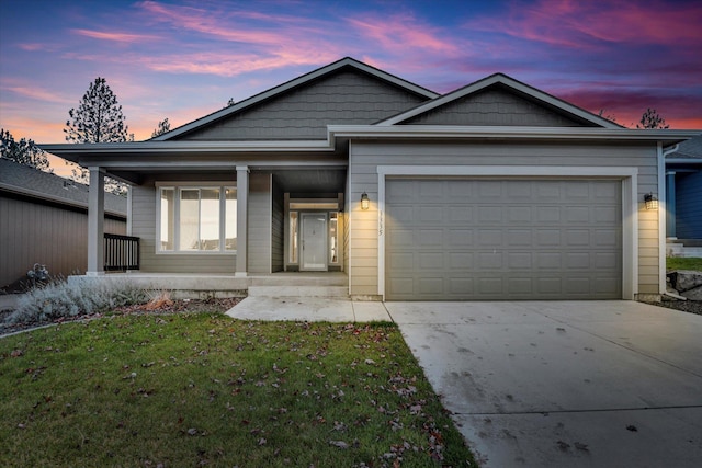 single story home with a porch, a garage, concrete driveway, and a front lawn