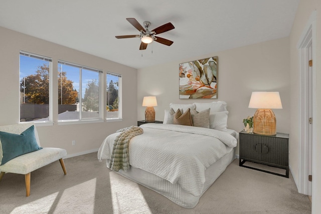 carpeted bedroom featuring baseboards and ceiling fan