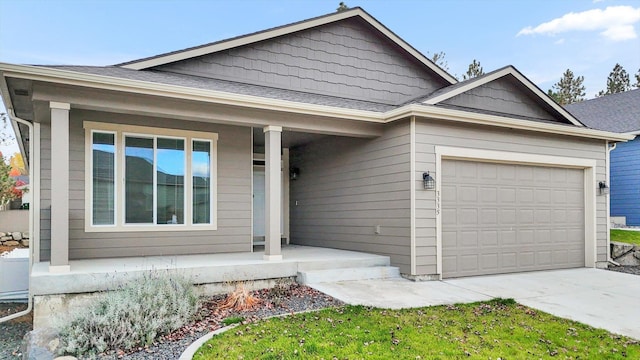 view of front facade featuring covered porch, a garage, and driveway