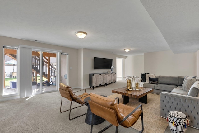 living room featuring light carpet and a textured ceiling