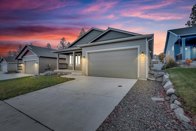 ranch-style home with a porch, driveway, a yard, and an attached garage