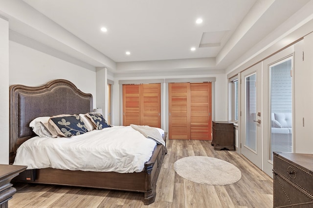 bedroom featuring french doors and light wood-type flooring