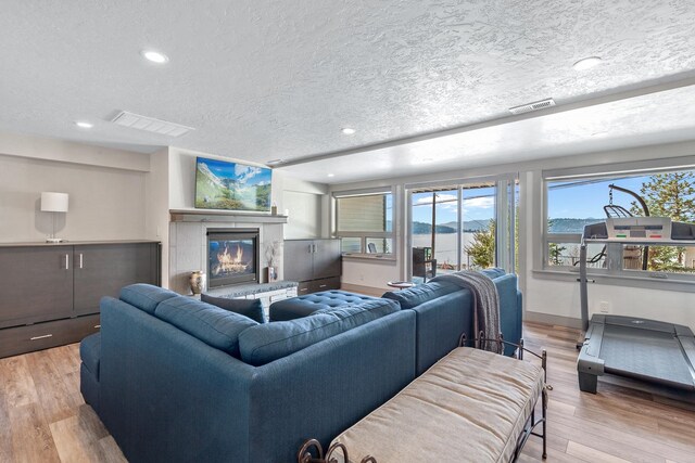 living room featuring light hardwood / wood-style flooring and a textured ceiling