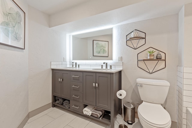 bathroom featuring vanity, toilet, and tile patterned floors