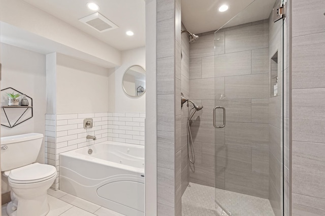 bathroom featuring toilet, independent shower and bath, tile patterned floors, and tile walls