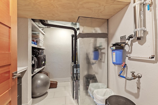 exercise room featuring light tile patterned floors