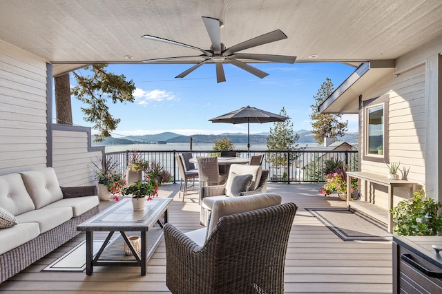 deck with a mountain view, an outdoor hangout area, and ceiling fan