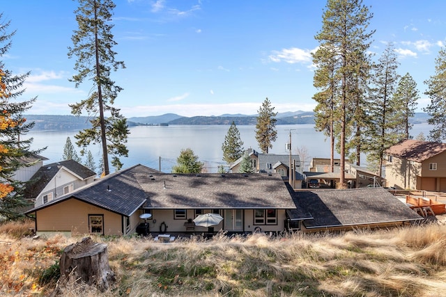 exterior space with a water and mountain view