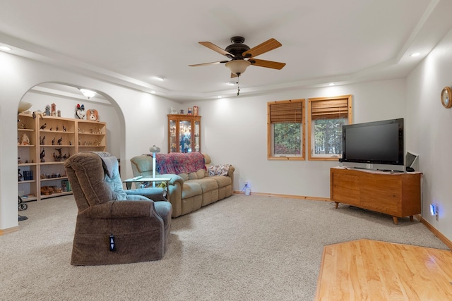 living room featuring carpet and ceiling fan