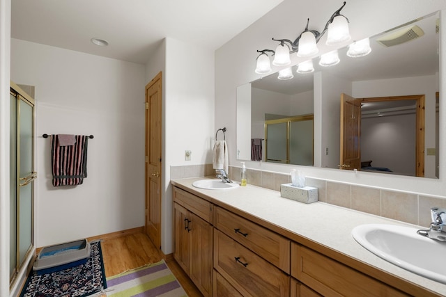 bathroom with vanity, walk in shower, and hardwood / wood-style flooring