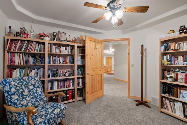 sitting room with carpet flooring and ceiling fan