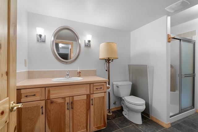 bathroom featuring vanity, tile patterned floors, toilet, and walk in shower