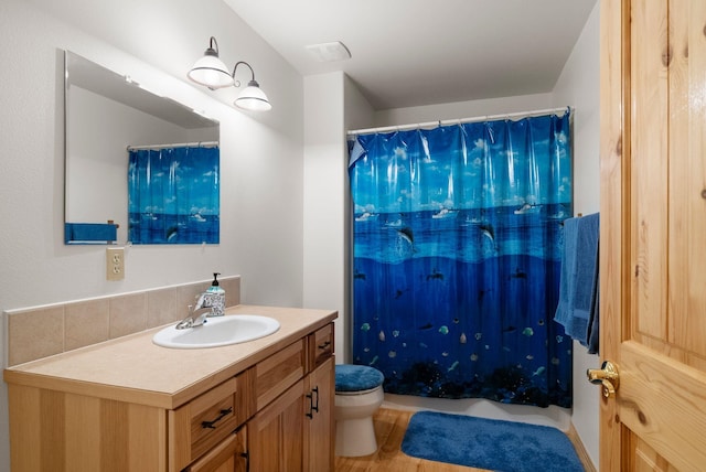 bathroom featuring vanity, hardwood / wood-style floors, toilet, and a shower with shower curtain