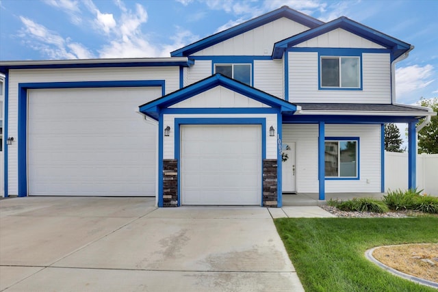 view of front of property featuring a garage and a front yard