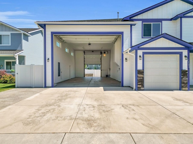 1005 S Oswald St, Spokane, WA 99224 - view of front of home with board and batten siding, driveway, and stone siding