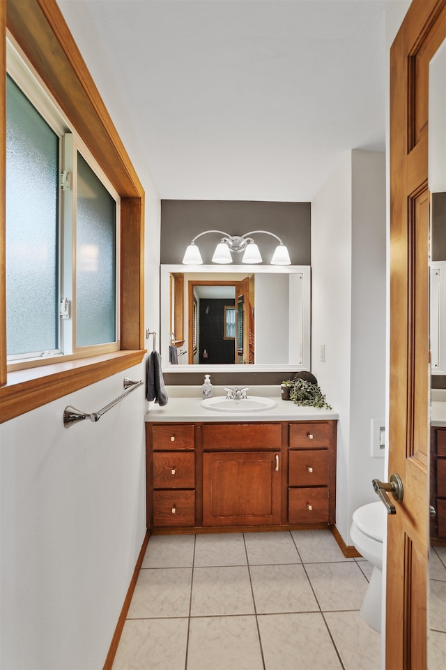 bathroom featuring tile patterned flooring, vanity, and toilet