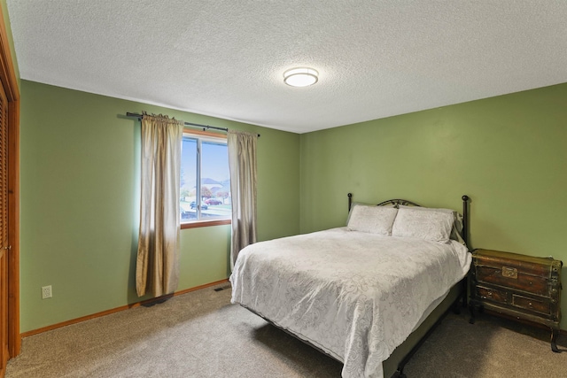 carpeted bedroom featuring a textured ceiling