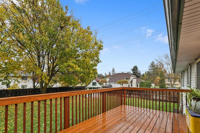 wooden deck featuring a lawn