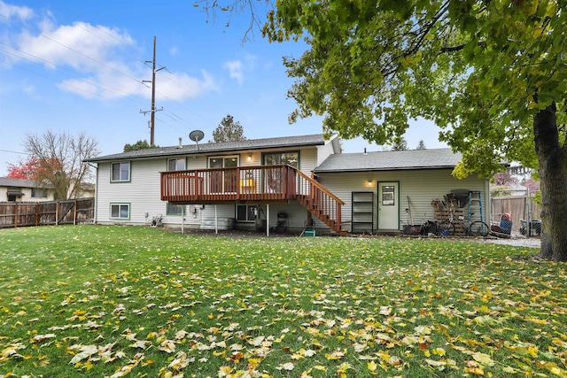 back of property with a yard and a wooden deck