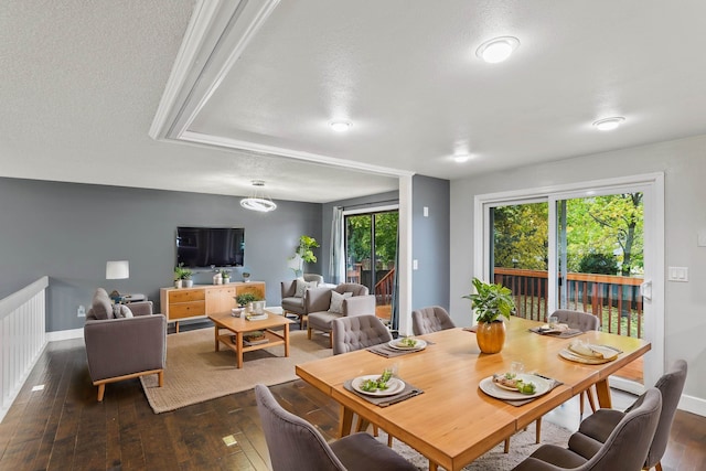 dining area featuring dark hardwood / wood-style flooring and a textured ceiling