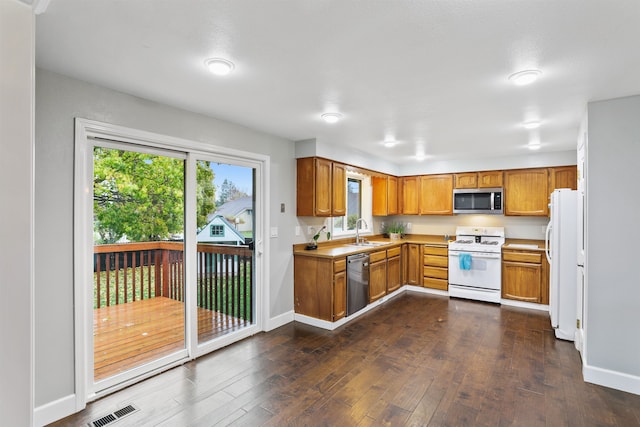 kitchen with dark hardwood / wood-style floors, sink, and appliances with stainless steel finishes