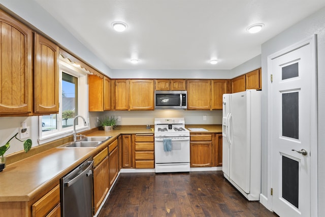 kitchen with dark wood-type flooring, sink, and stainless steel appliances