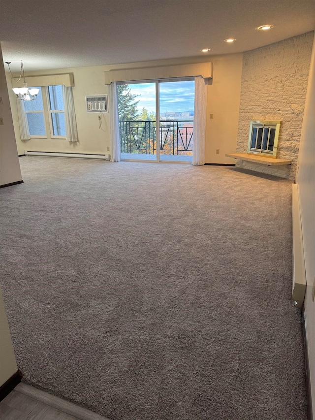 unfurnished living room with a stone fireplace, a baseboard heating unit, and carpet floors