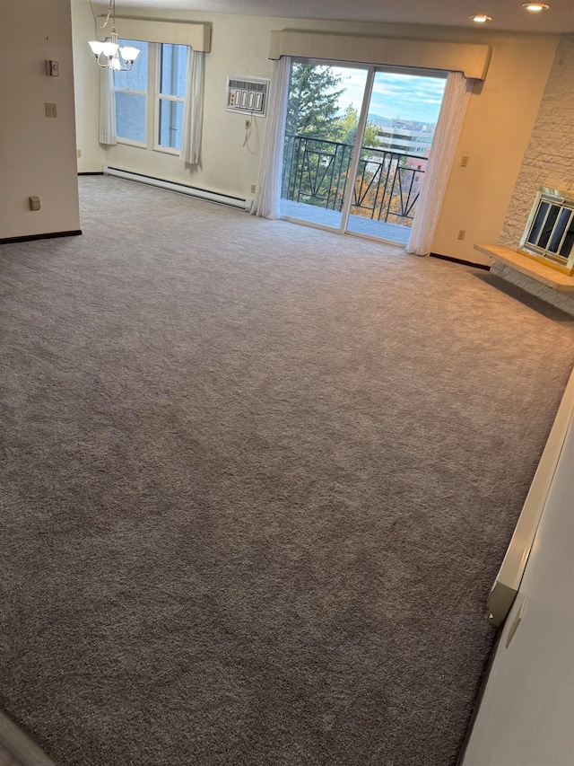 unfurnished living room featuring a baseboard heating unit, a fireplace, carpet floors, and a wall mounted air conditioner