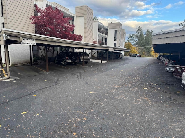 view of parking / parking lot featuring a carport