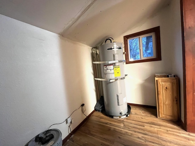 utility room featuring strapped water heater