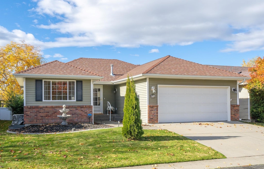 view of front of property featuring a garage and a front lawn