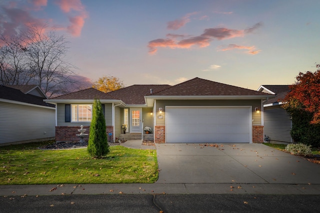 view of front of property featuring a lawn and a garage