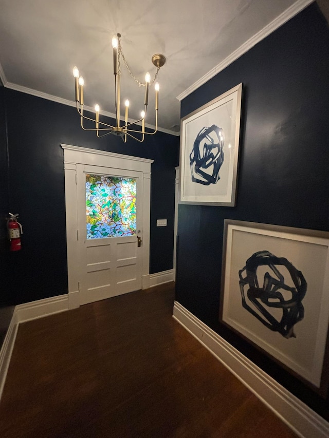 doorway featuring dark hardwood / wood-style flooring, a chandelier, and ornamental molding