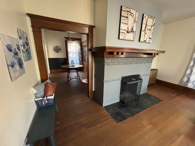 interior space with hardwood / wood-style flooring and a brick fireplace