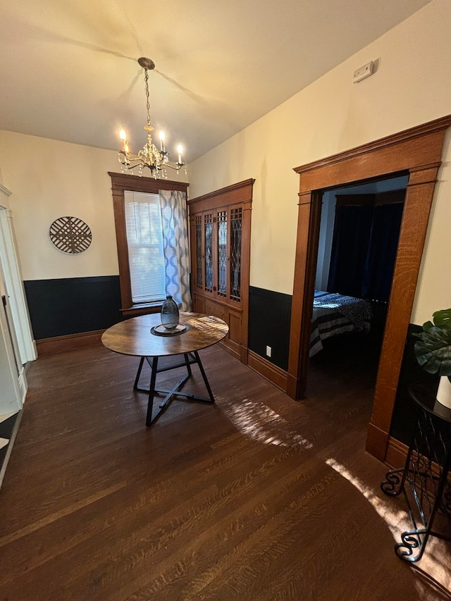 interior space with dark wood-type flooring and a notable chandelier