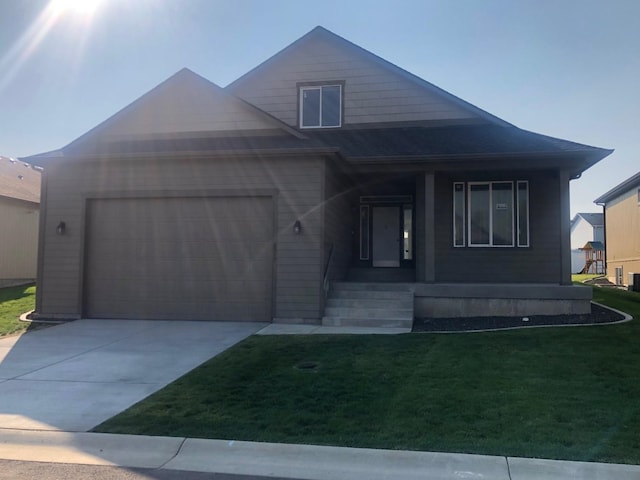 view of front of home with a garage and a front lawn