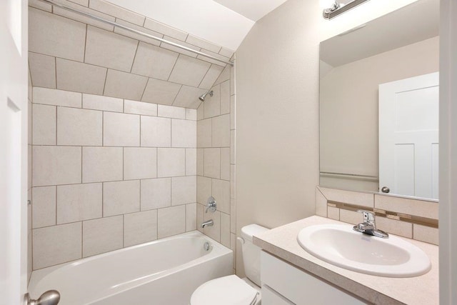 full bathroom with toilet, vanity, tiled shower / bath combo, and lofted ceiling