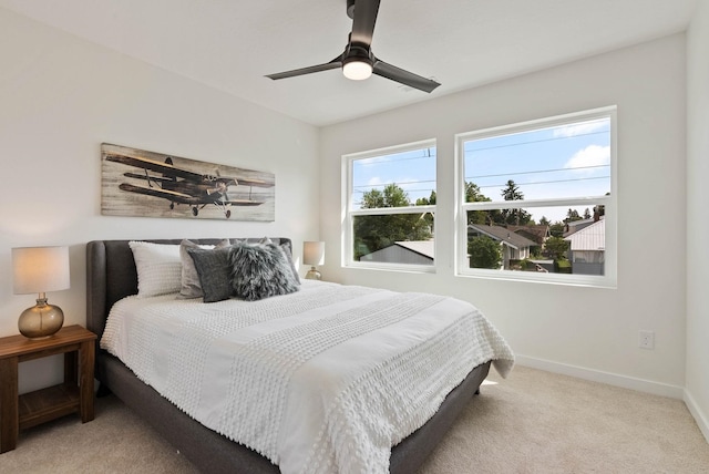 bedroom featuring light colored carpet and ceiling fan