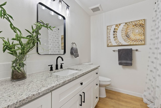 bathroom featuring hardwood / wood-style floors, vanity, and toilet